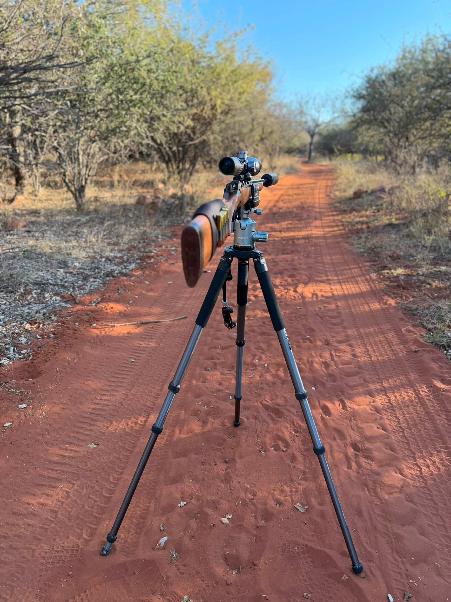 Front view of the RokStad FLA Aluminum Shooting Tripod (RSAL-T01) supporting a rifle on the RoKstad 55mm Quick Stop Ball Head (RSRH-03)