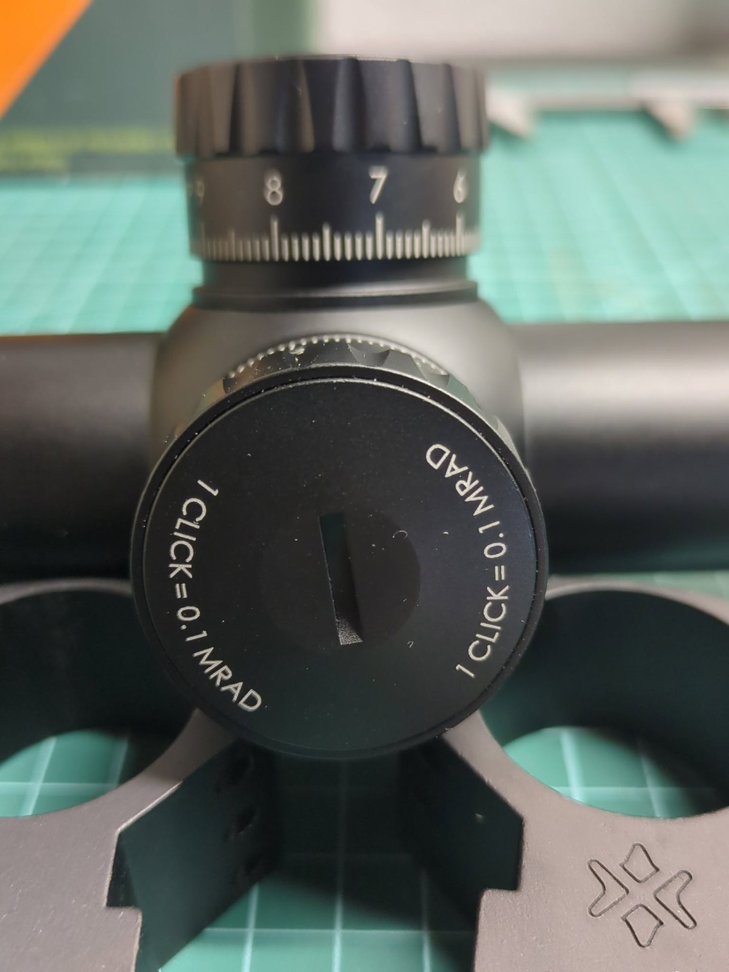 Tauron GenII 3-24x56 ED turret close-up showing 0.1 MRAD per click