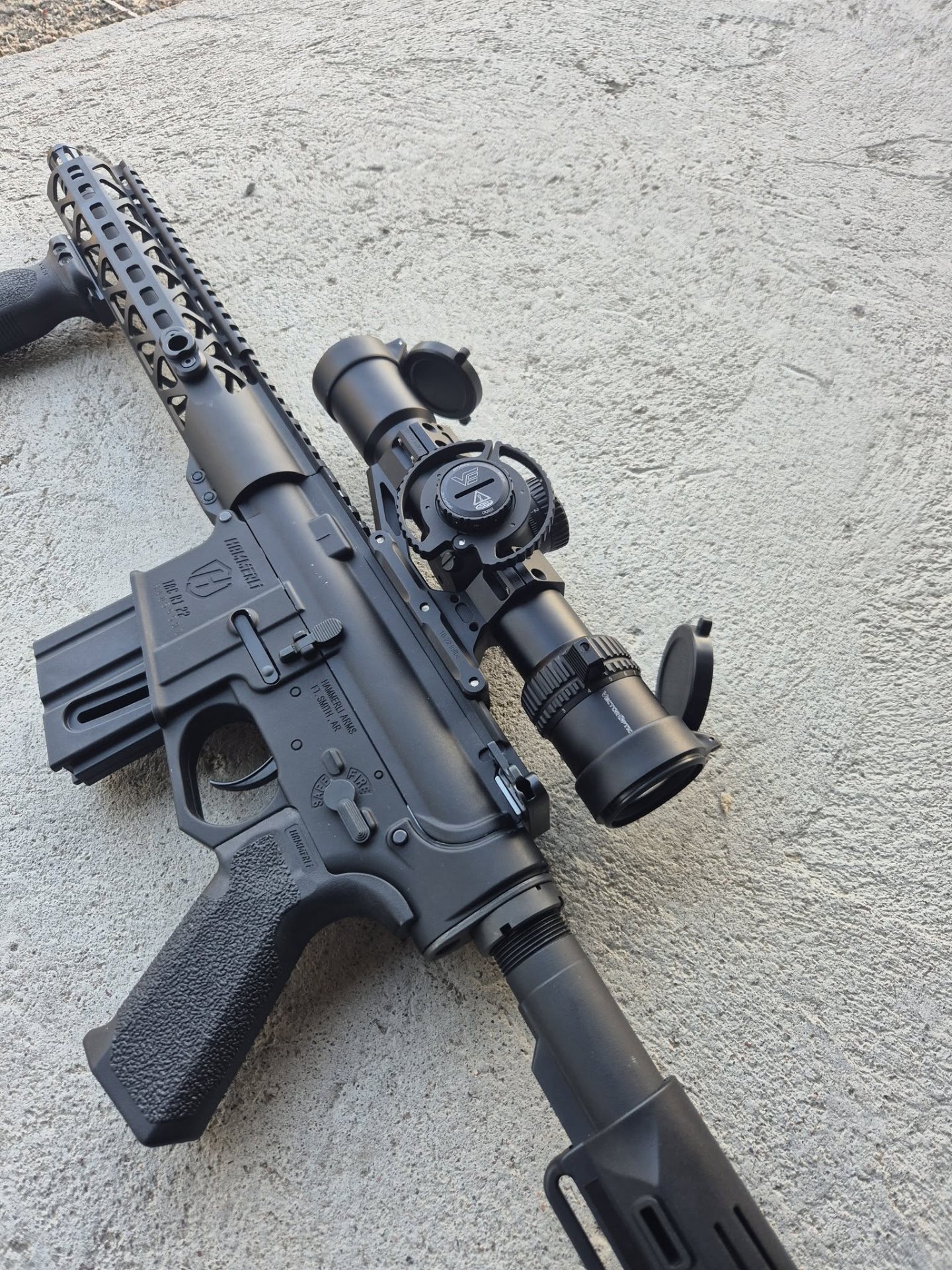 Rifle with the Veyron GenII 2-10x32 HD CTR rifle scope lying on concrete