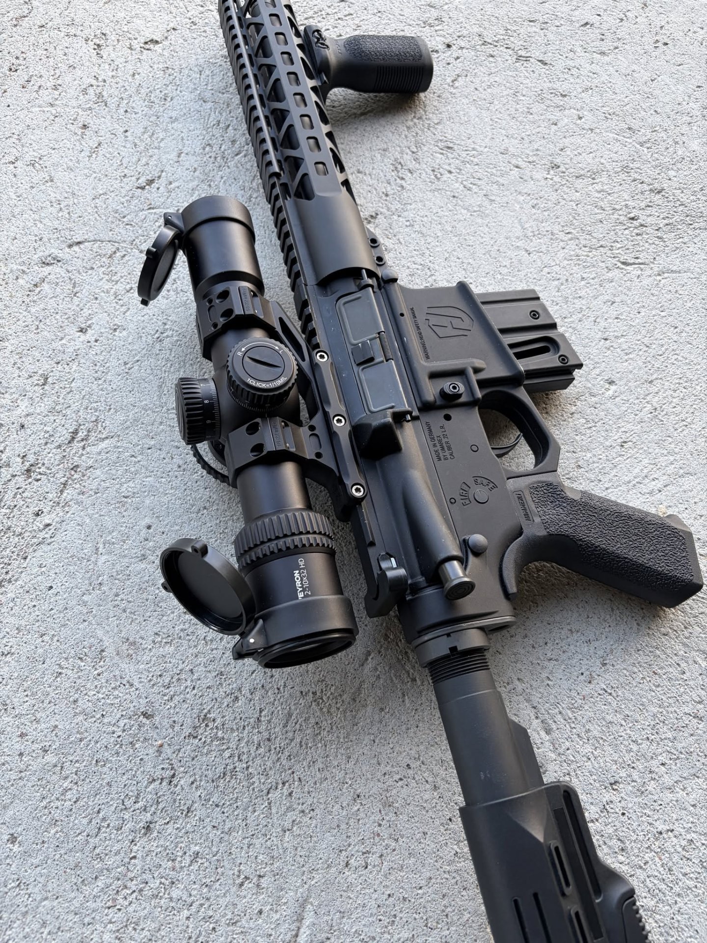 Veyron GenII 2-10x32 HD CTR rifle scope mounted on a rifle against a rock