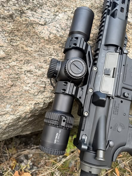 Veyron GenII 2-10x32 HD CTR rifle scope mounted on a rifle next to a rock